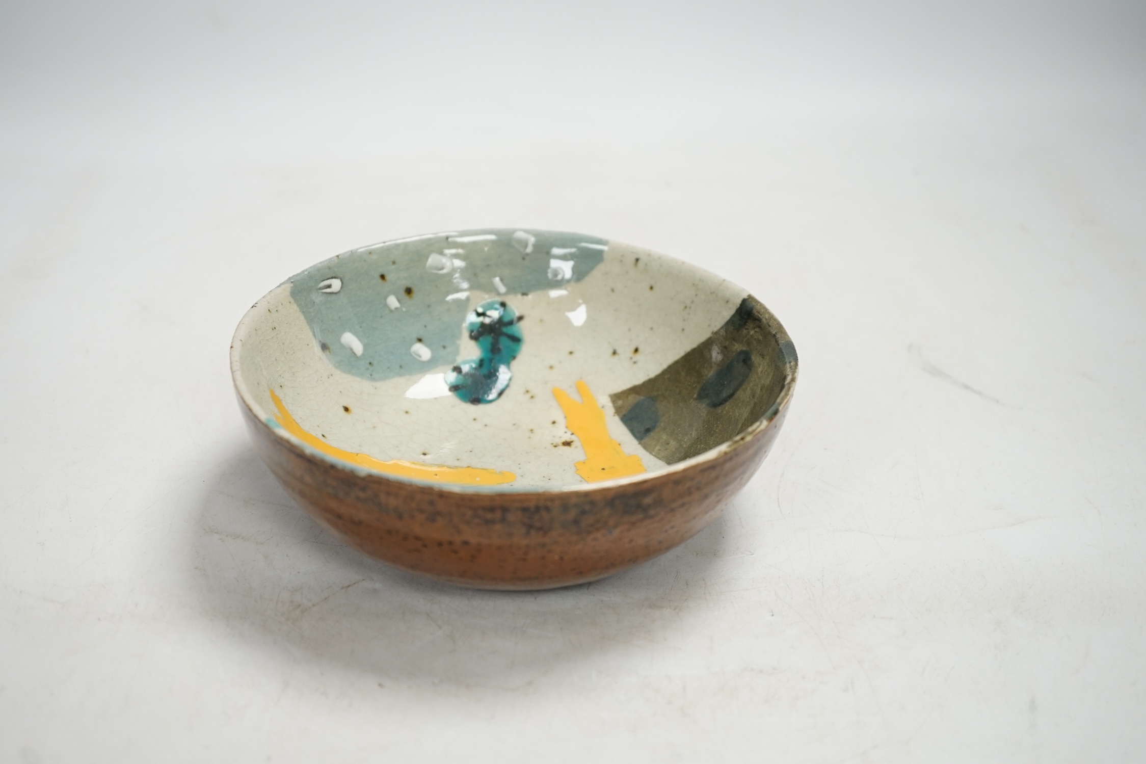 John Maltby (1936-2020), a studio pottery bowl decorated with yellow fish, 16cm. Condition - good